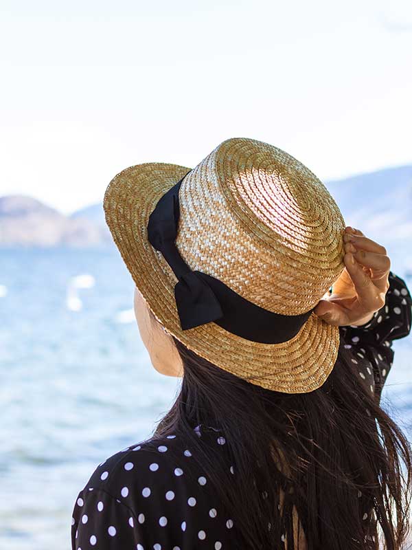 woman wearing a hat while in the sun-ON BEACH BOUTIQUE & GIFTS